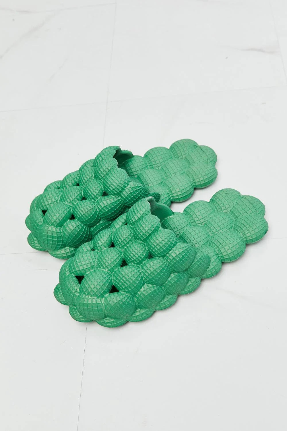 Cosy green bubble slide slippers with plush cushioning and slip-on design