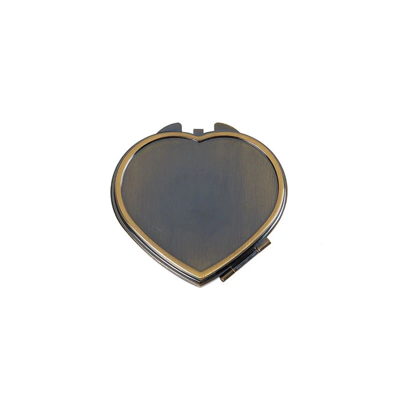 Heart-shaped metal pill box with built-in mirror for convenient storage and touch-ups on the go