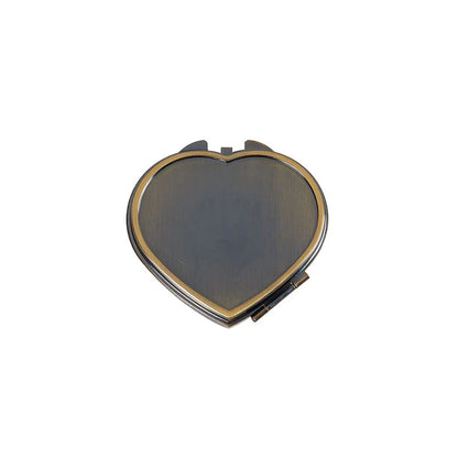 Heart-shaped metal pill box with built-in mirror for convenient storage and touch-ups on the go