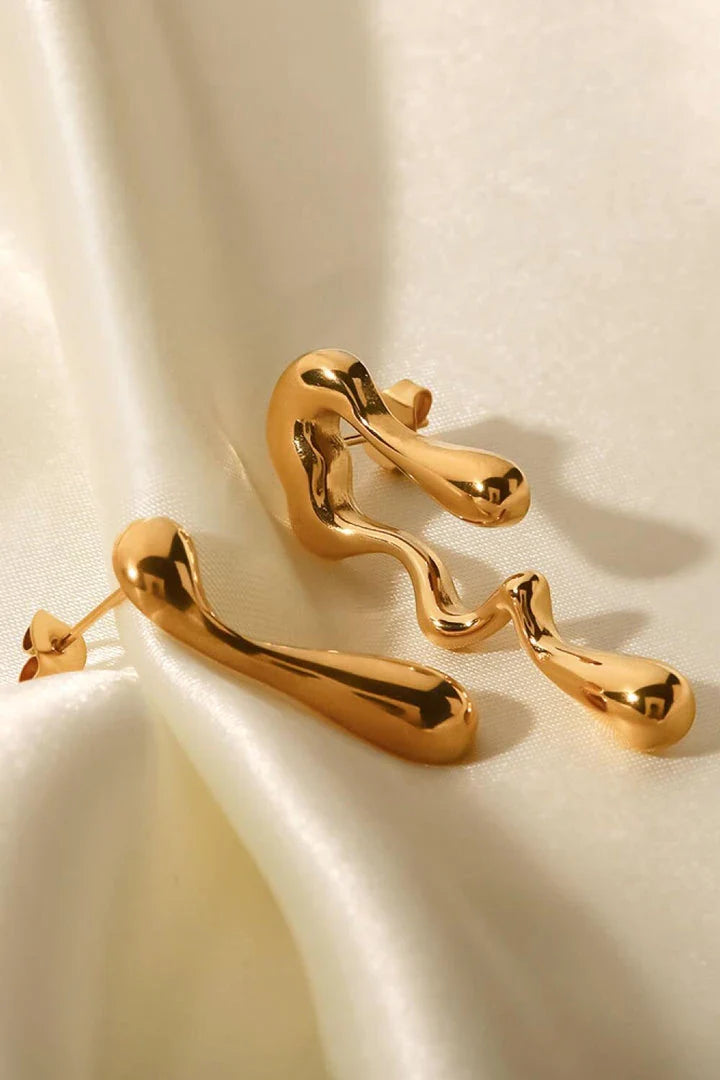 Pair of 18K gold-plated geometric mismatched earrings with varying lengths and shapes