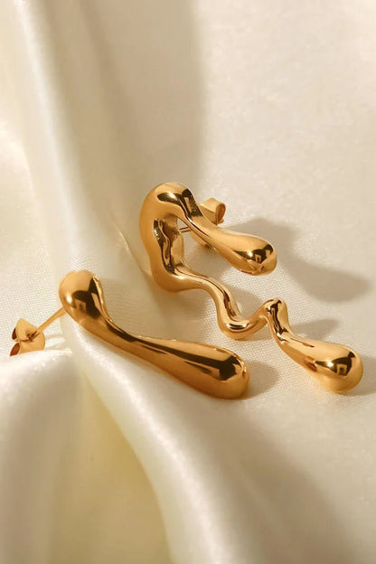Pair of 18K gold-plated geometric mismatched earrings with varying lengths and shapes