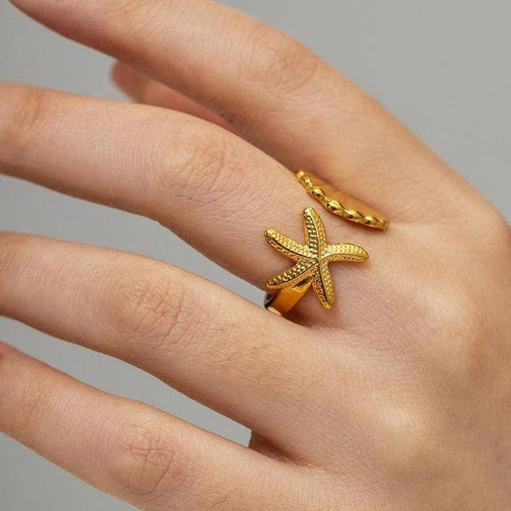Adjustable stainless steel ring with starfish and shell accents, perfect for beach and casual wear