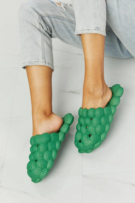 Cosy green bubble slide slippers with plush cushioning and slip-on design