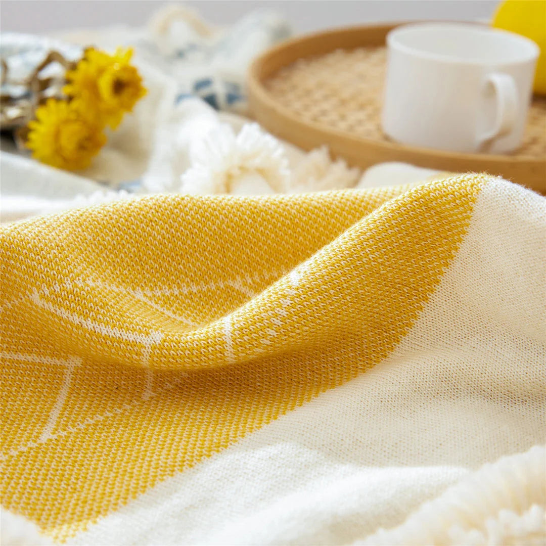 Cosy cotton tufted throw blanket with a geometric pattern and tassels in a soft yellow colour