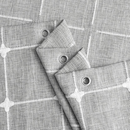 Elegant jacquard linen shower curtain with a geometric pattern and charming tassel accents, available in multiple sizes and colours for a premium bathroom upgrade.