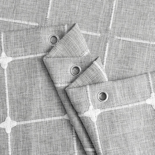 Elegant jacquard linen shower curtain with a geometric pattern and charming tassel accents, available in multiple sizes and colours for a premium bathroom upgrade.