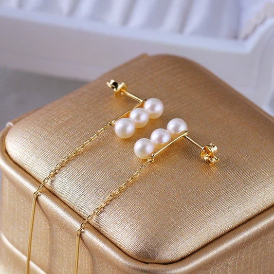 Elegant natural pearl earrings in a sleek silver frame, a timeless accessory for any occasion