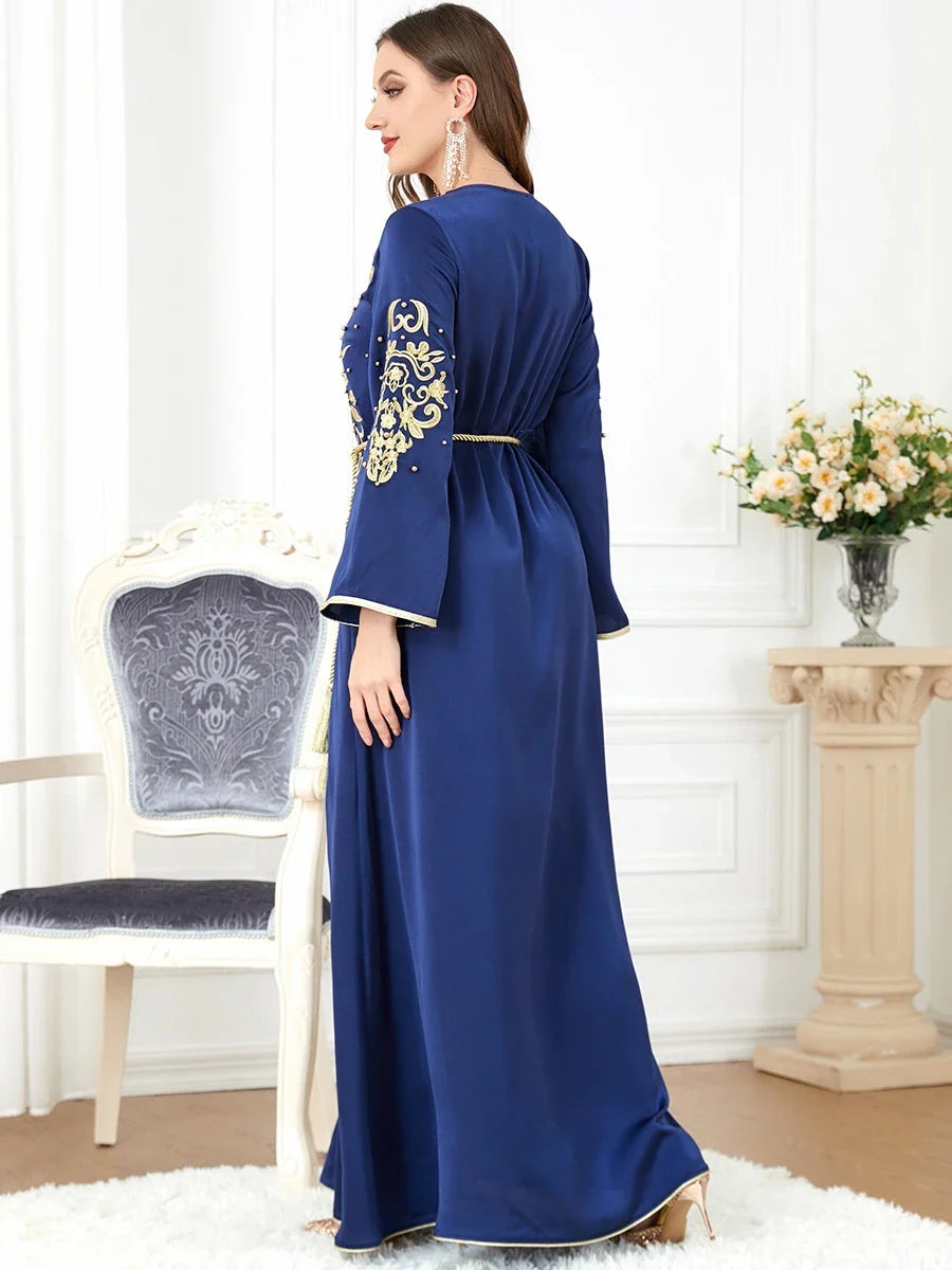 A sophisticated long-sleeve women's dress with a captivating floral embroidery pattern and a refined colour palette, suitable for a variety of occasions.
