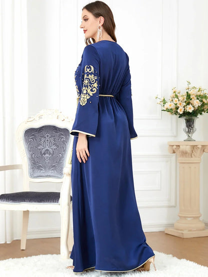 A sophisticated long-sleeve women's dress with a captivating floral embroidery pattern and a refined colour palette, suitable for a variety of occasions.