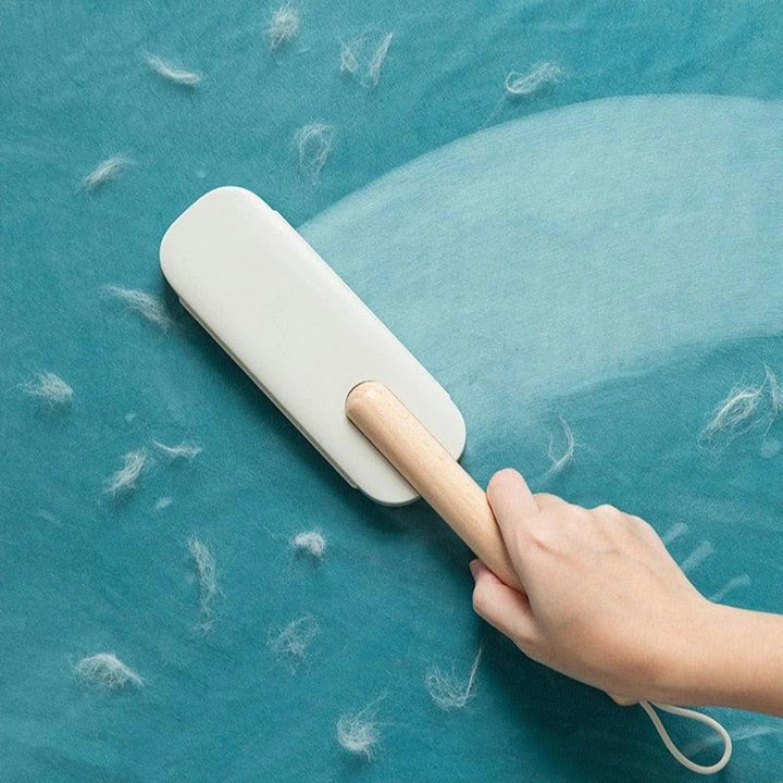 Premium pet hair removal brush with grey handle and bristles, designed for use in UK homes