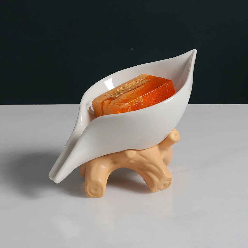 Elegant ceramic leaf-shaped soap holder with a sturdy base, adding a touch of nature-inspired sophistication to any bathroom
