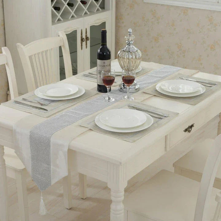 Elegant crystal-trimmed table runner with 4 coordinating beige placemats, creating a refined and sophisticated dining setting