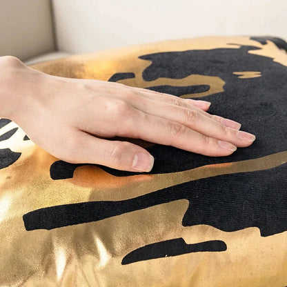 Pair of Nordic-inspired geometric plush pillowcases with a luxurious gold pattern on a white and black background