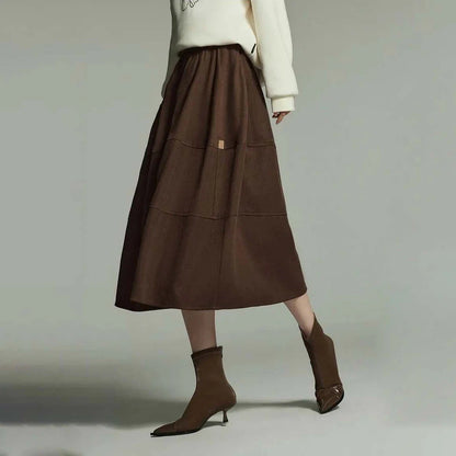 A stylish and sophisticated mid-length A-line pleated skirt with pockets, crafted from high-quality twill fabric for durability and comfort.