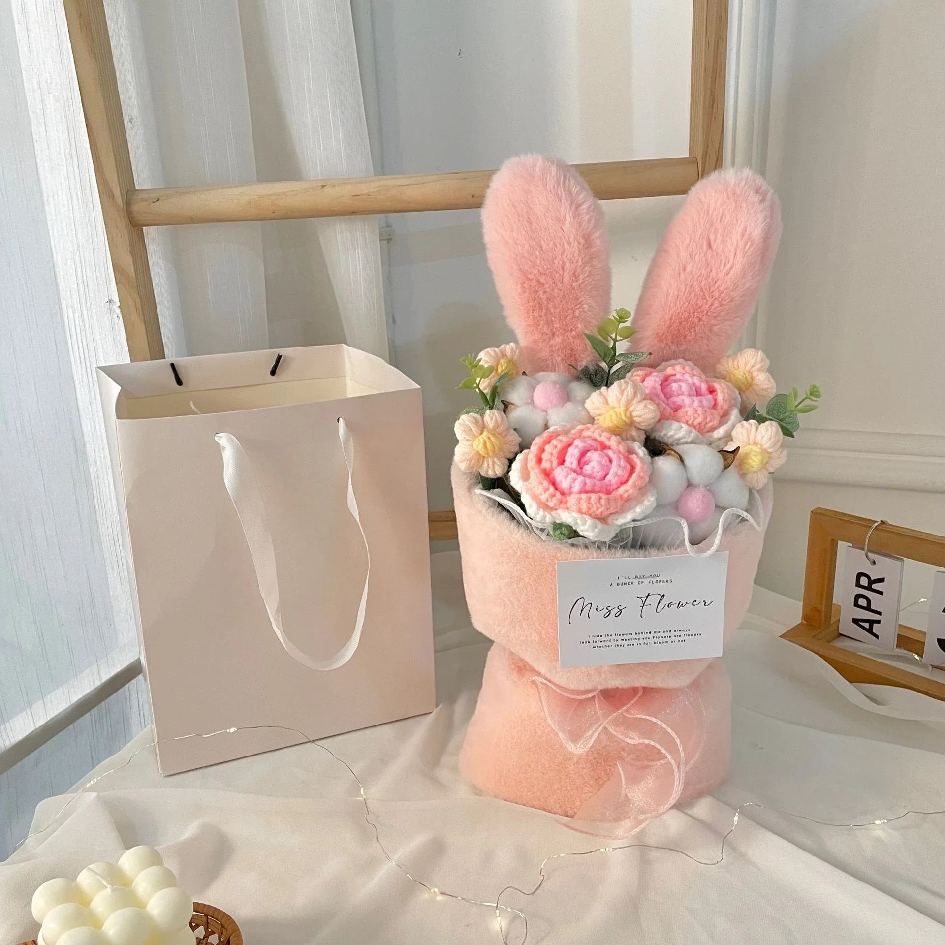 A delightful knitted rabbit bouquet doll in vibrant colours, featuring soft plush materials and a charming design