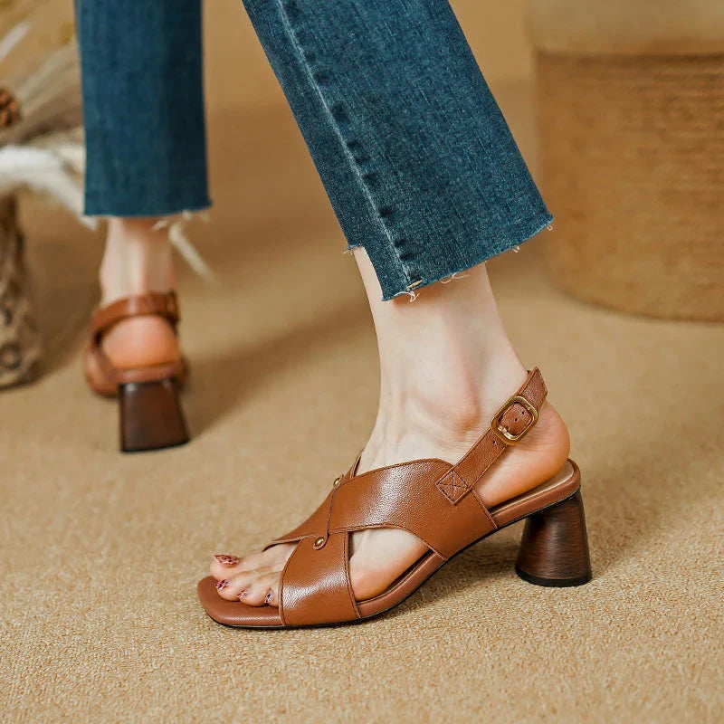 Elegant leather high heel sandals in khaki colour for women, featuring a 5.5 cm square heel, secure buckle strap, and sleek design.