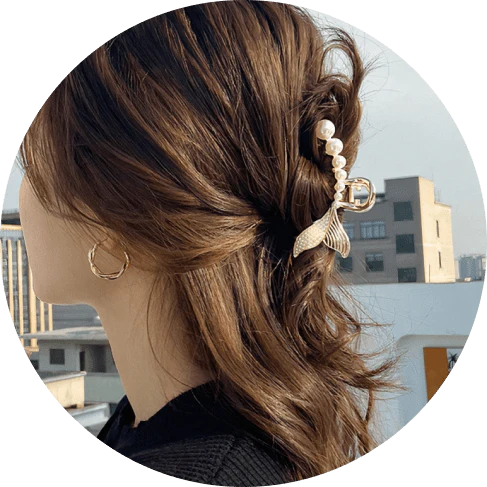 Elegant gold-toned mermaid tail hair clips adorned with faux pearls, creating a captivating and enchanting accessory for mermaid lovers.