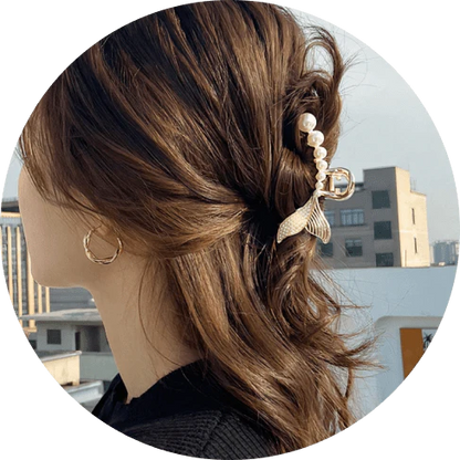 Elegant gold-toned mermaid tail hair clips adorned with faux pearls, creating a captivating and enchanting accessory for mermaid lovers.