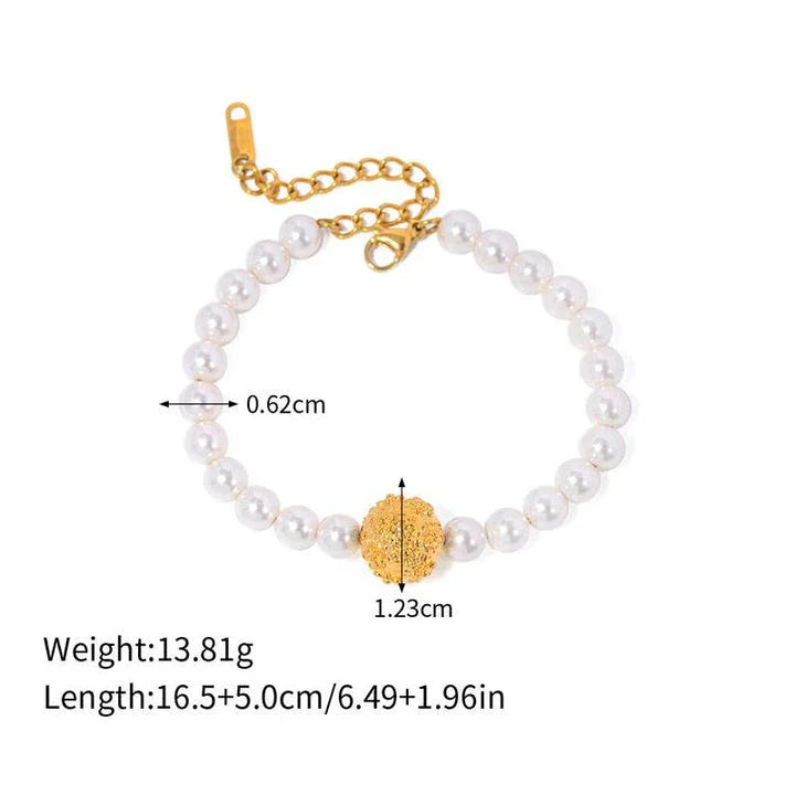 An elegant 18K gold-plated stainless steel bracelet featuring a flower ball design with a lustrous pearl centre