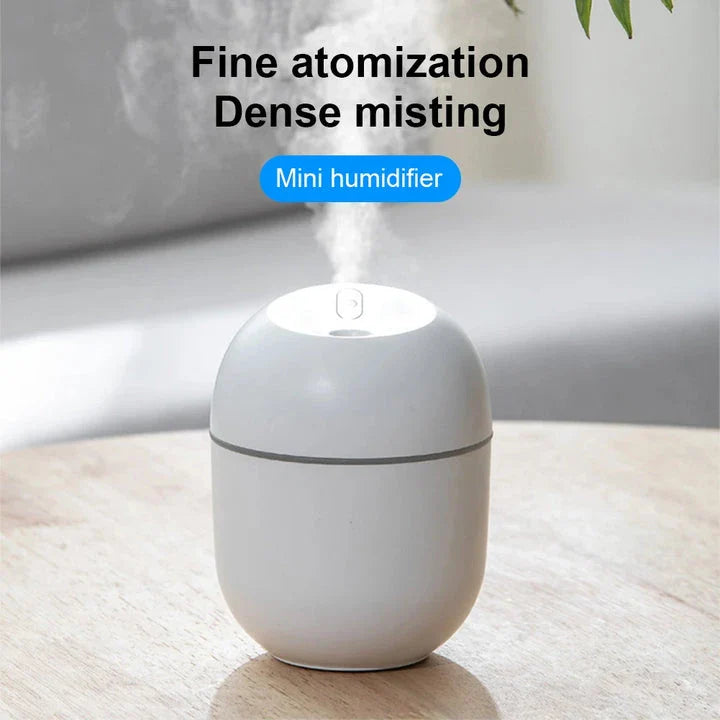Compact ultrasonic humidifier and aroma diffuser with LED night light, designed for use in home or office spaces.