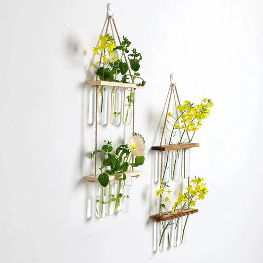 Elegant bamboo hydroponic wall vase with a sleek glass tube suspended in a wooden frame, displaying lush greenery