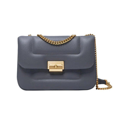 Grey leather crossbody bag with adjustable metal shoulder strap and secure hasp closure