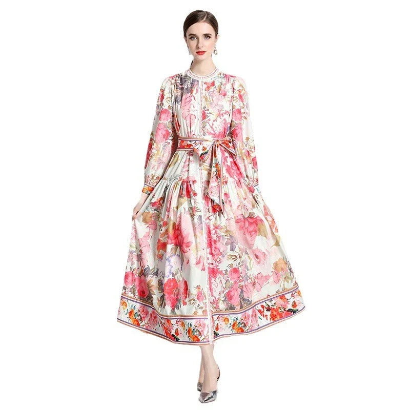 Elegant floral single-breasted swing dress with delicate print, tailored design, and flowing silhouette
