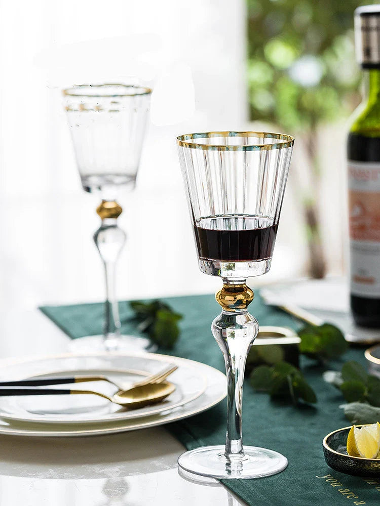 Elegant crystal wine glasses with a gold vertical pattern design, perfect for enjoying your favourite wines in style.