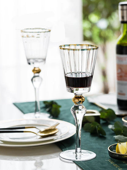 Elegant crystal wine glasses with a gold vertical pattern design, perfect for enjoying your favourite wines in style.