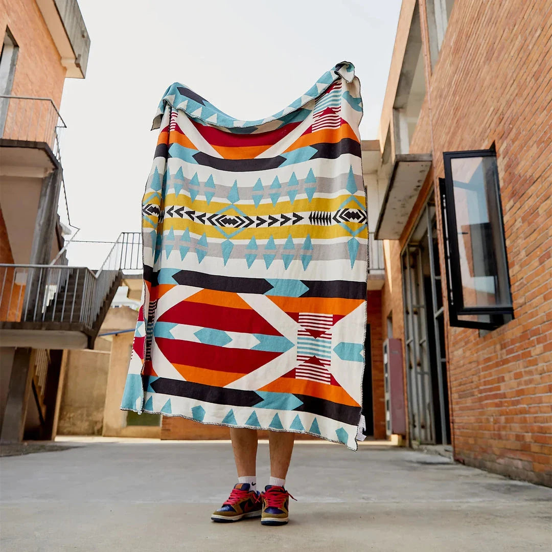 Cosy bohemian-style cotton blanket with vibrant geometric pattern, suitable for indoor and outdoor use