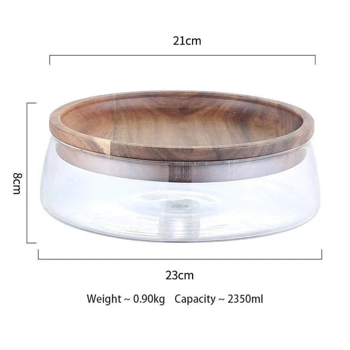 A transparent glass storage canister with a wooden lid, offering elegant and functional kitchen storage