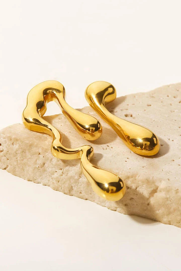 Pair of 18K gold-plated geometric mismatched earrings with varying lengths and shapes