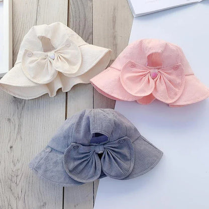 Adorable pink princess baby bucket hat with bow detail for sun protection and fashionable wear