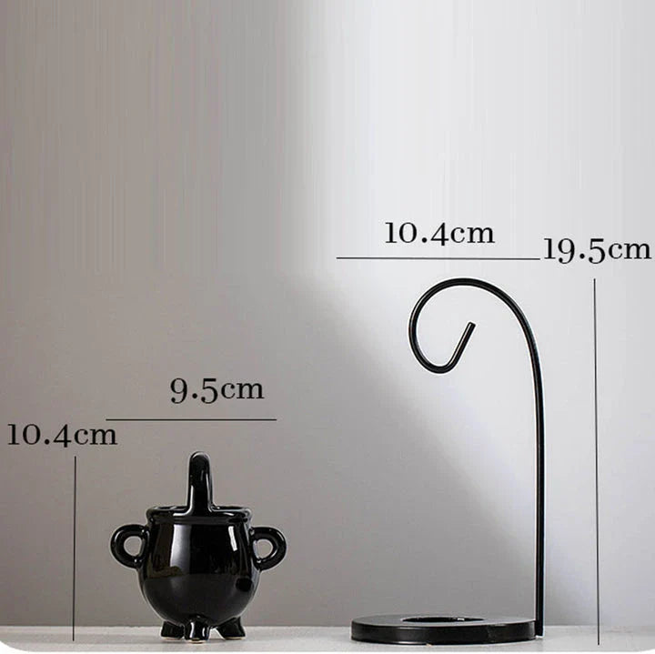 Captivating iron frame essential oil diffuser and candle holder with a unique witch's soup cup design