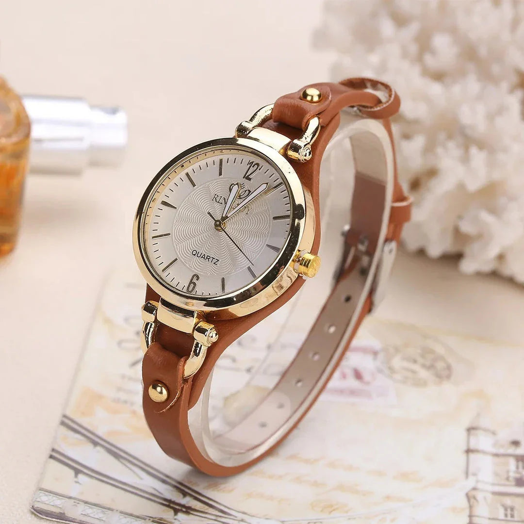 Elegant women's quartz watch with a black leather strap, featuring a sleek alloy case and a durable glass dial window
