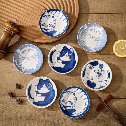 Charming Japanese ceramic sauce dish with a lucky cat design, perfect for serving sauces, sushi, and more.
