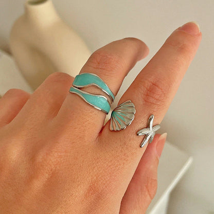Adjustable stainless steel ring with starfish and shell accents, perfect for beach and casual wear
