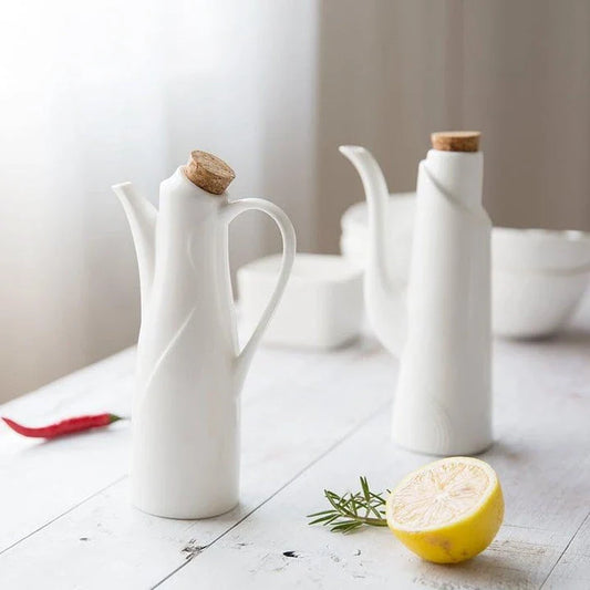 Elegant white porcelain storage bottles with Mediterranean-inspired design for kitchen organisation and decor