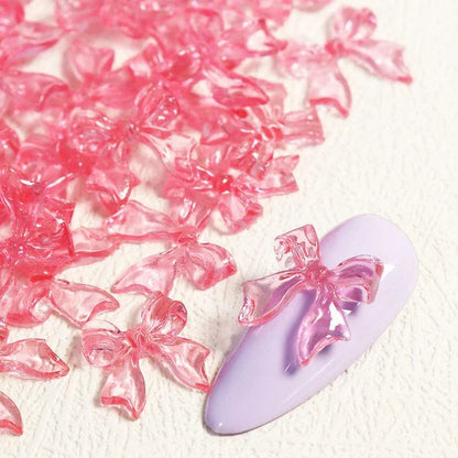Charming candy-coloured bow nail charms in various colours, perfect for adding a playful touch to your manicure