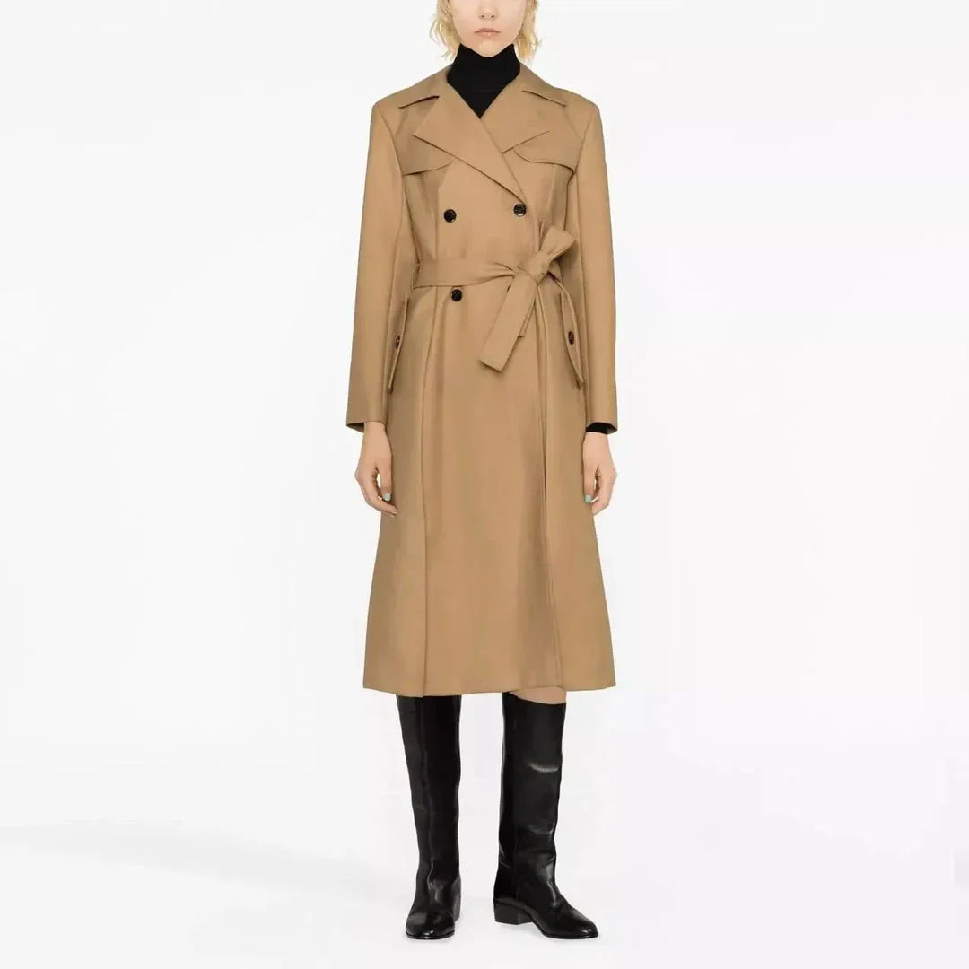 Elegant double-breasted women's trench coat in beige, featuring a classic collar, wide-waisted design, and practical pockets for a sophisticated and timeless look.