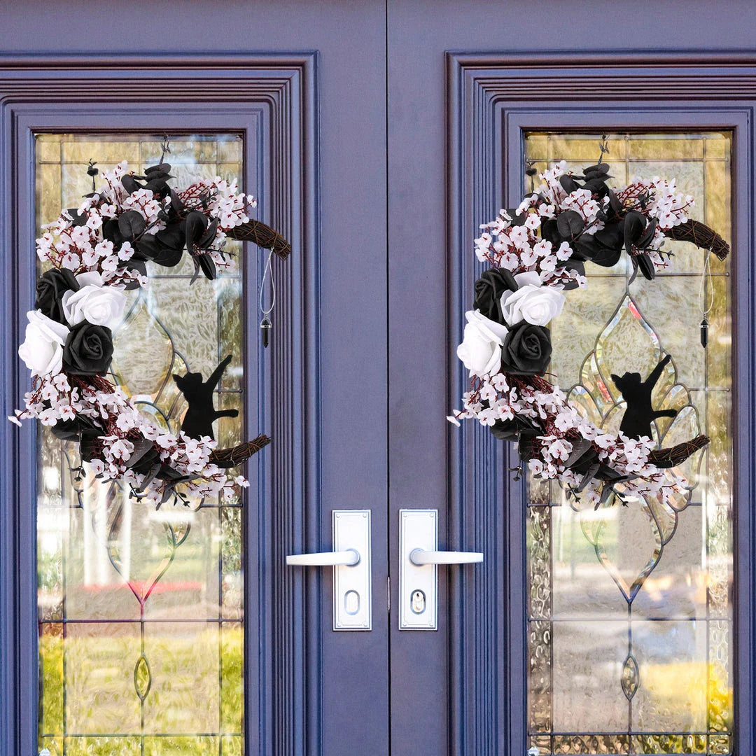 Spooktacular Halloween garland featuring a blend of dried white flowers, black roses, and mystical moon cat ornaments