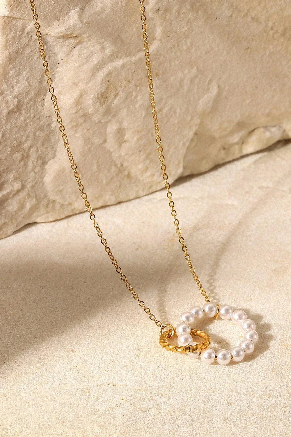 Elegant 18K gold-plated pearl hoop necklace with a lustrous synthetic pearl centrepiece