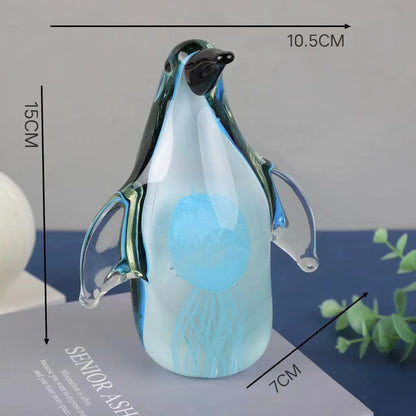 Exquisite handcrafted glass penguin ornament with a striking green-backed design, showcasing the beauty of marine life