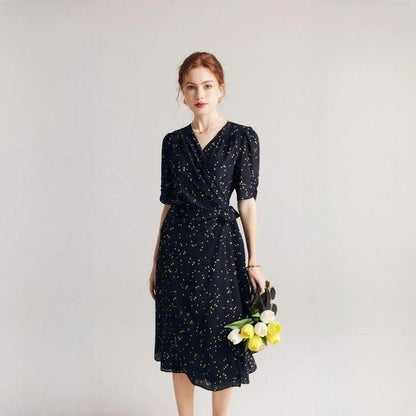 Elegant black polka dot silk wrap dress with V-neck and empire waistline, perfect for formal and casual occasions