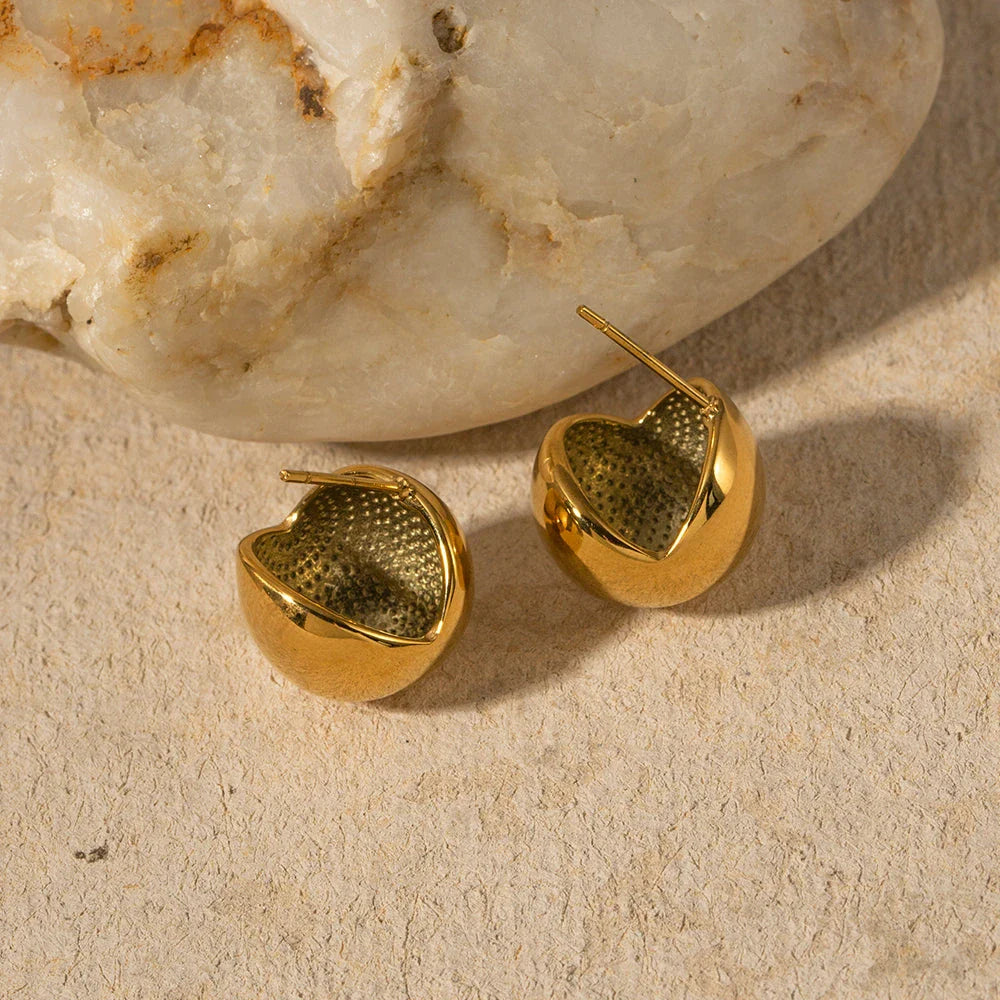 A pair of stylish, 18K gold-plated hemispherical cutout earrings with a sleek, sophisticated design