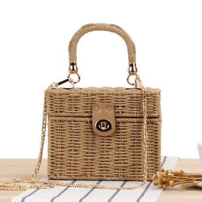 Handcrafted natural straw beach bag with bohemian-inspired design and detachable metal chain strap
