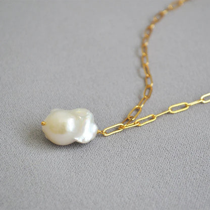 Elegant freshwater pearl necklace with a unique fish tail-shaped pendant and a delicate O-shaped chain