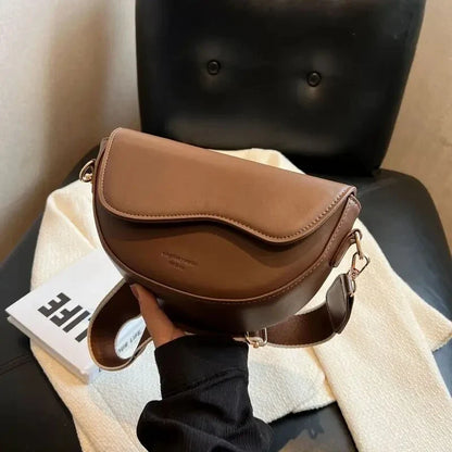 A stylish pillow-shaped shoulder bag made of high-quality PU leather, featuring a crossbody and messenger design for versatile use.