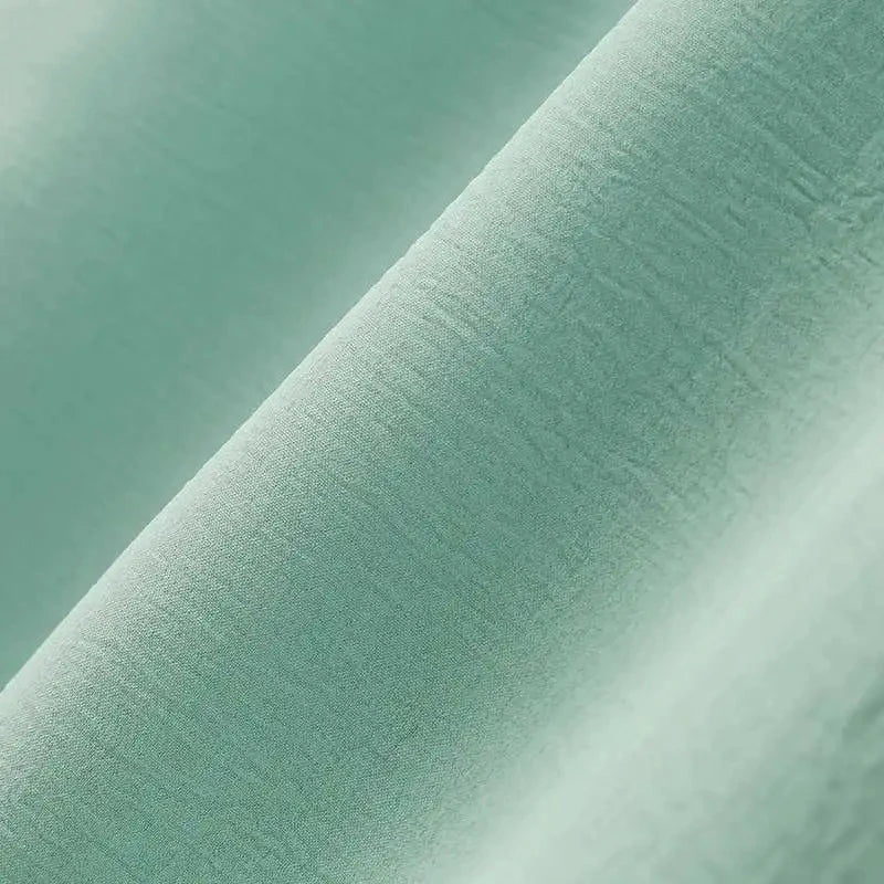 A stylish Muslim women's dress made from luxurious ice silk fabric with long sleeves and a high slit hem, available in a range of classic British colours.