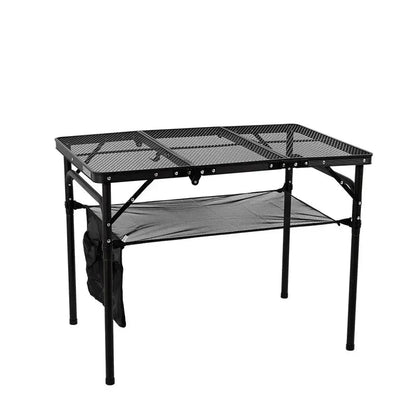 Adjustable portable folding camping table with aluminium frame, black in colour, set up outdoors